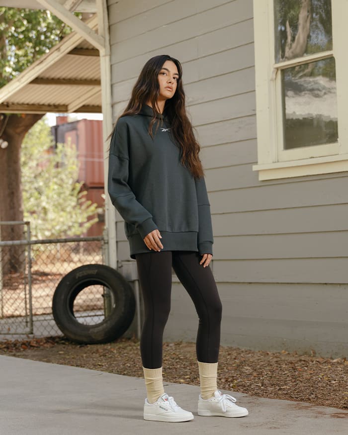 Young woman wearing a sports bra and a Reebok legging in nature