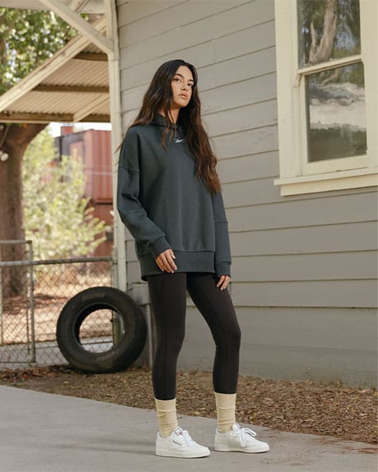 Young woman wearing a sports bra and a Reebok legging in nature