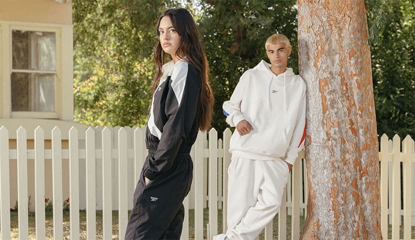 Young woman wearing a pink Reebok hoodie and a white Reebok tshirt