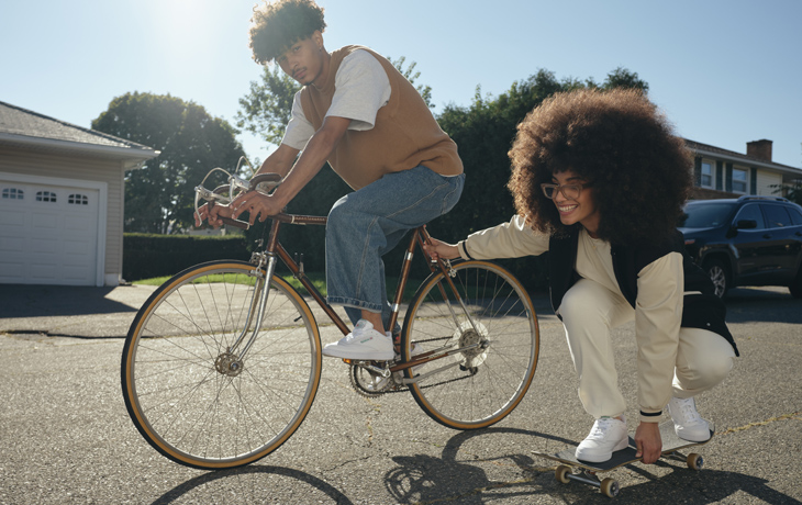 Young woman and men wearing Reebok Classic clothing and shoes